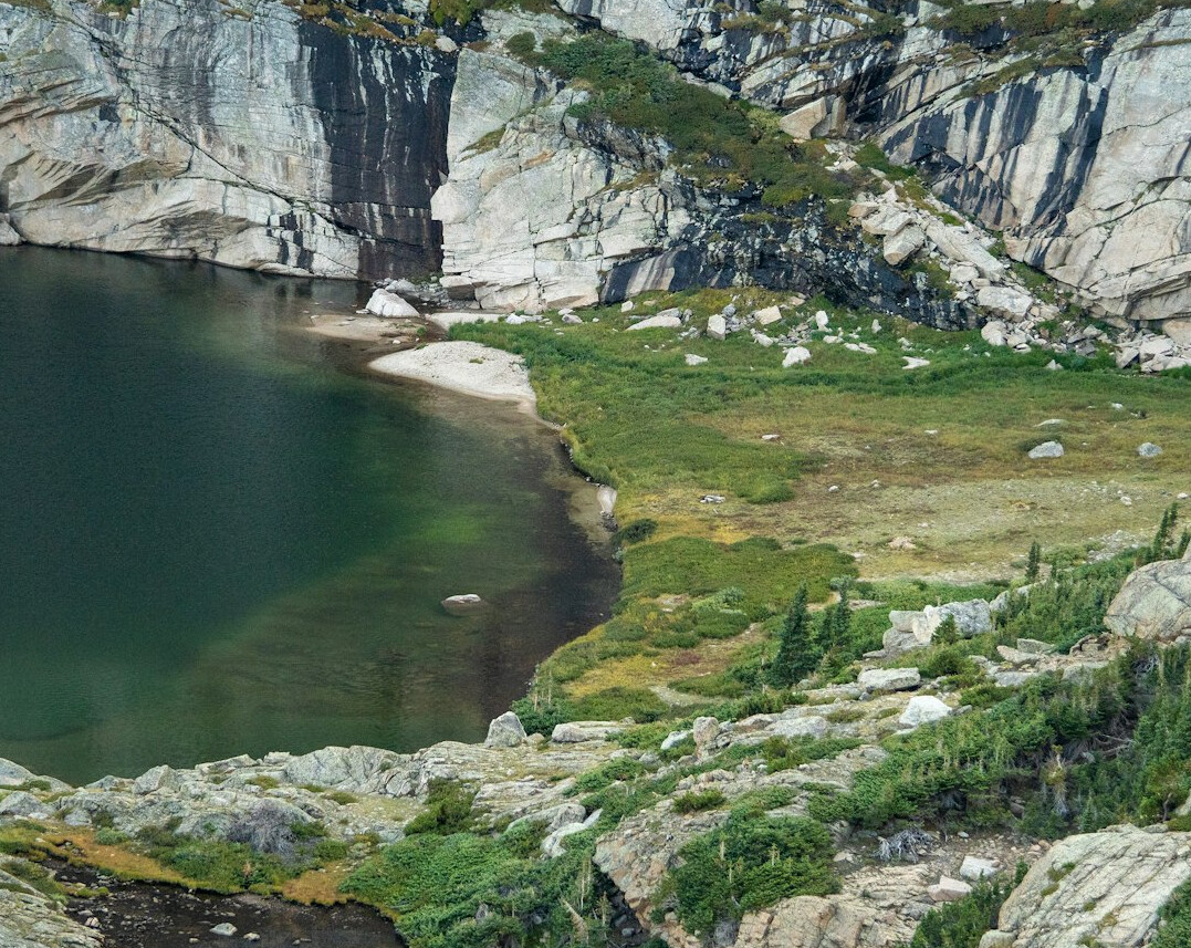 Lake with forested hills and mountains in the distance