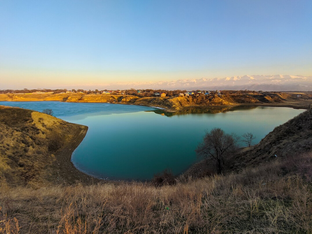 Mountain valley with lake at sunset