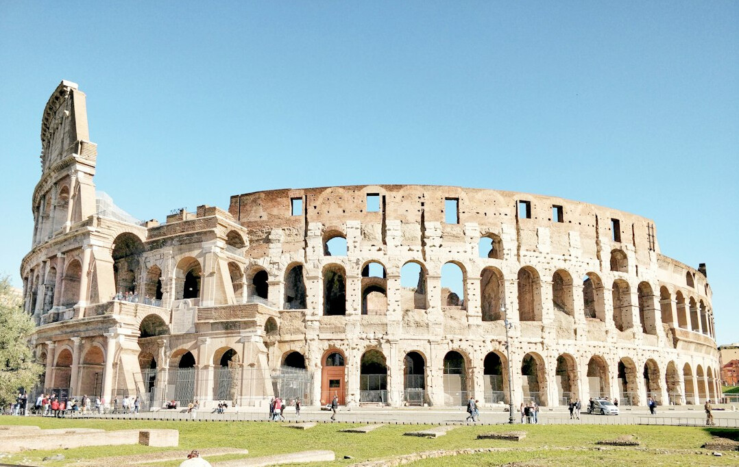 Colosseum in Rome at daytime with blue sky