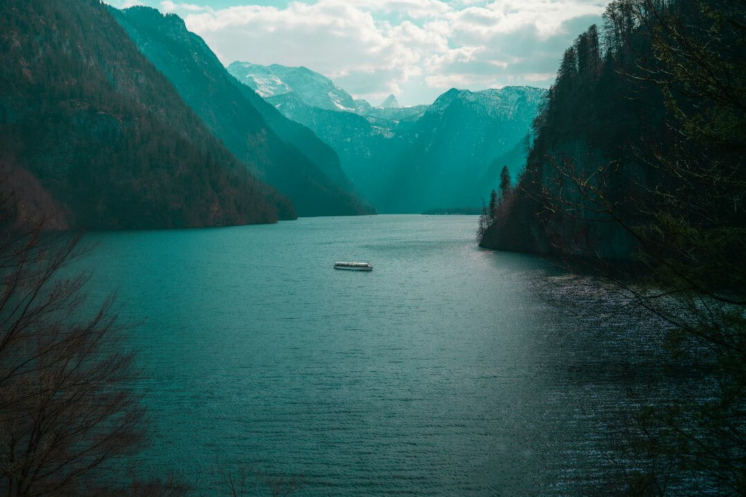 Alpine lake surrounded by mountains with a small boat