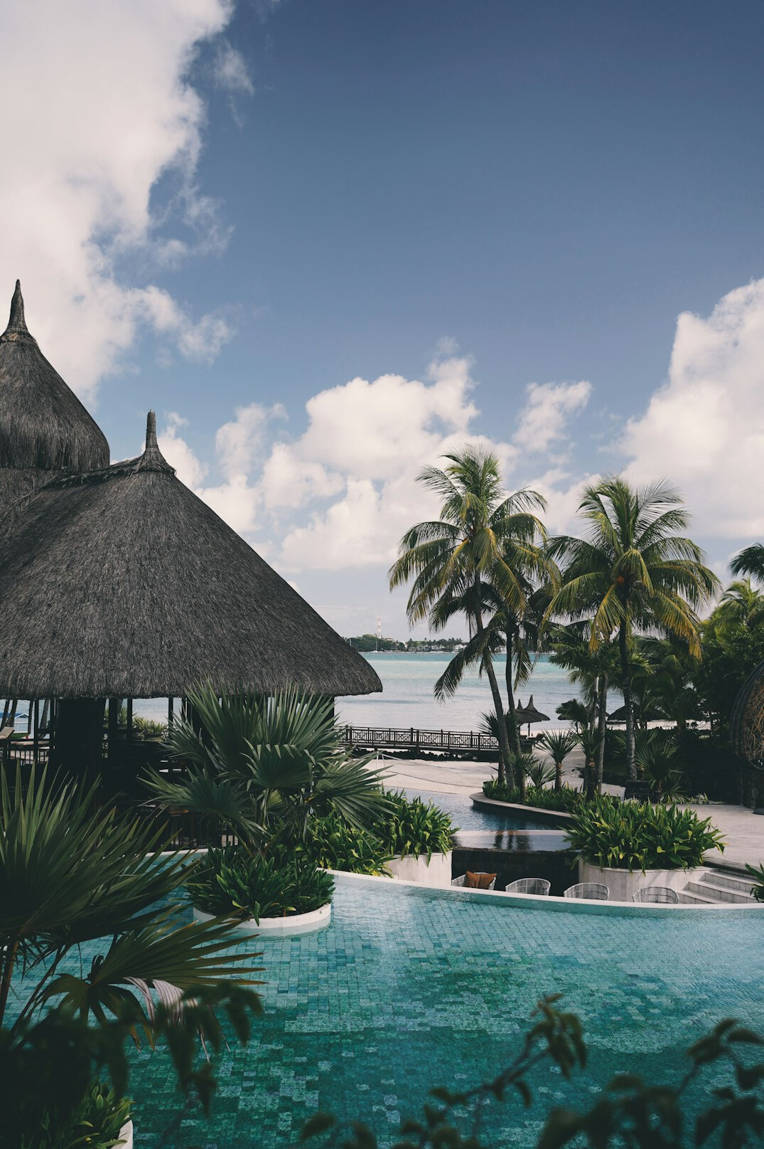 Seaside resort with pool and palm trees